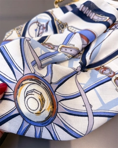 Close-up of vintage carriage print on high-quality silk scarf with twill texture detail