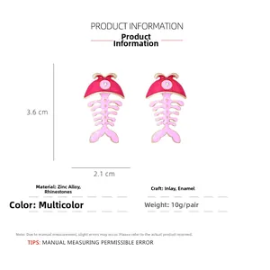 Detailed view of pink enamel fish bone earrings with rhinestone and size scale
