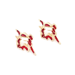Detail view of gold alloy earrings with irregular red enamel melting lava texture