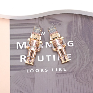 Sparkly nutcracker drop earrings with pink rhinestones on a fashion magazine