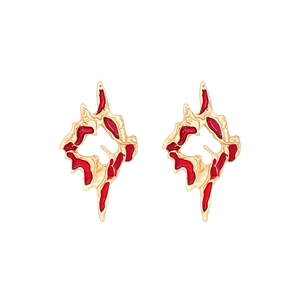 Irregular gold alloy earrings with red enamel glaze featuring a lava-inspired hollow texture