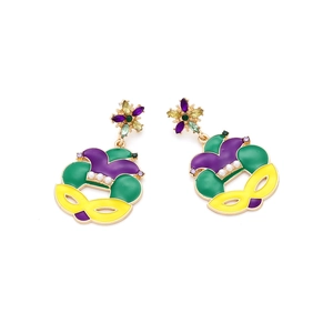 Detailed view of Mardi Gras mask earrings with purple green enamel and faux pearls