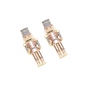 Detailed view of nutcracker earrings with pink rhinestones and gold alloy frame