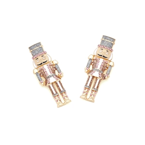 Detailed close-up of nutcracker soldier earrings with pink crystals and gold-tone finish
