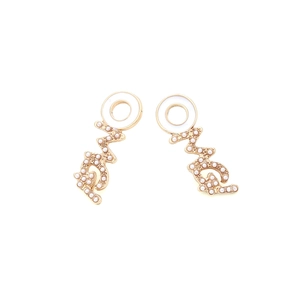 Detail of gold letter earrings with white resin rings and small faux pearls accents