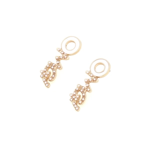 Detail of LOVE letter earrings featuring gold finish, faux pearls and white enamel