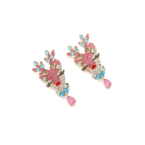Macro view of colorful crystal reindeer earrings with pink teardrop crystal drops