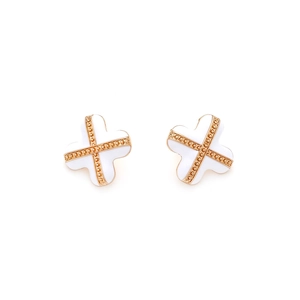 Detailed macro view of white enamel four-leaf clover earrings with gold metal accents