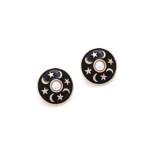 Detail of round black enamel stud earrings with gold star moon motifs and faux pearl