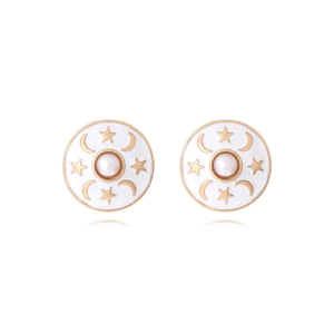 Macro detail of round enamel earrings with pearl center and golden star moon motifs