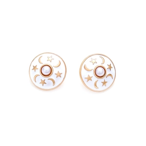 Detail of round star and moon enamel stud earrings with centered pearl and gold trim