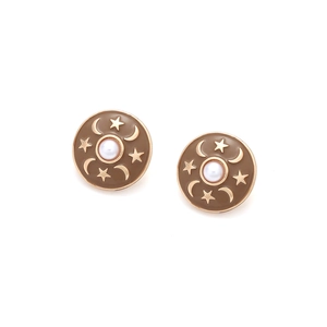 Macro view of vintage round stud earrings with brown enamel stars and moon pearl detail