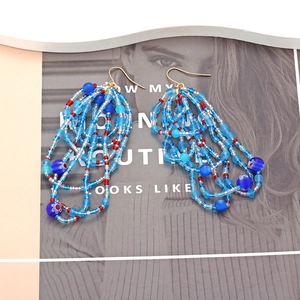 Bohemian handmade beaded tassel earrings with blue and red seed beads in a layered ethnic style