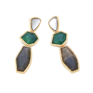 Detailed macro view of layered geometric earrings with emerald and grey resin stones