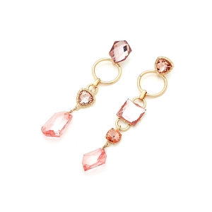 Close-up of pink crystal geometric drop earrings with gold-tone metal settings