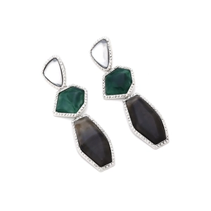 Close-up of geometric resin drop earrings with marble textures and pavé crystal borders
