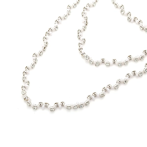 Elegant multi-layer necklace with faux pearls and sparkling rhinestone chains on white background