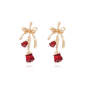 Elegant gold bow earrings with red enamel rose pendants on a clean white background