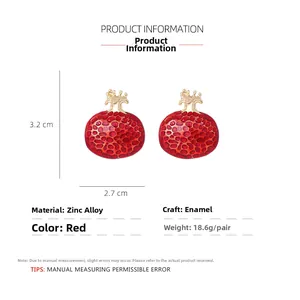 Detail view of red enamel pomegranate earrings with dimensions 3.2cm height and 2.7cm width