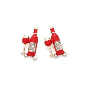 Macro detail of wine bottle and glass earrings with red enamel and white rhinestones