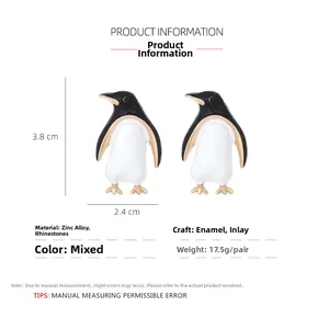 Detail showing zinc alloy penguin earrings with brown oil drip finish and crystal inlay