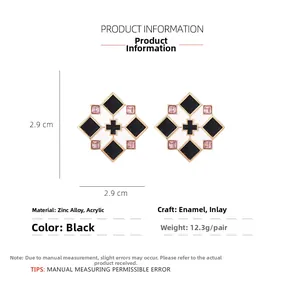 Detailed view of 2.9cm square brown plaid earrings with gold cross and pink crystals