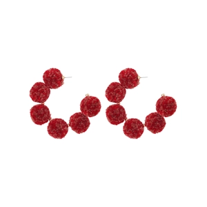 Retro C-shaped earrings with red handmade plush balls on a golden metal hoop