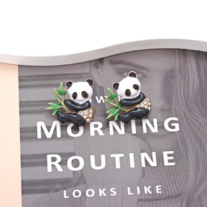 Cute panda earrings with green bamboo and sparkling crystals in a chic macro shot