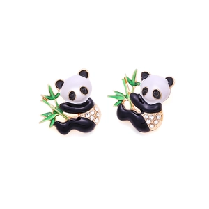 Detail of panda earrings with black white enamel, green bamboo and sparkling rhinestones