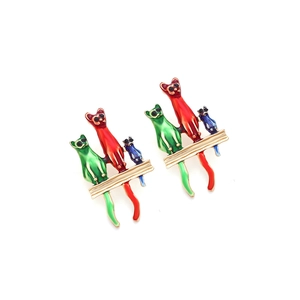 Detalle de pendientes de gato de esmalte colorido con tres gatos en barra dorada