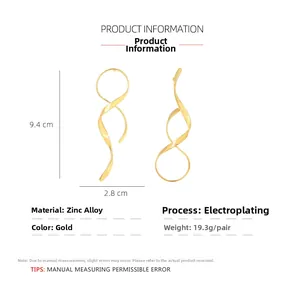 Detail view of large gold spiral ribbon earrings with dimensions and material specs