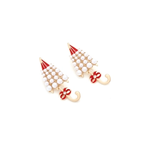 Detailed view of pearl umbrella earrings with red enamel bows and golden alloy finish