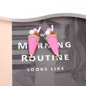 Detail of pink milkshake earrings with colorful rhinestones and pearl embellishments