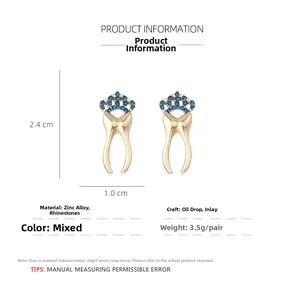 Detailed view of gold-tone crown tooth stud earrings with blue rhinestones and dimensions