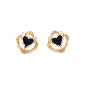 Detailed view of elegant gold heart earrings with black enamel and sparkling rhinestones