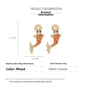 Detail view of gold koi fish earrings with orange rhinestones and 3.1x1.4cm dimensions