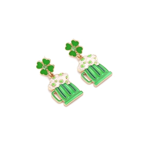 Detail of green enamel beer mug and four-leaf clover earrings for St. Patrick's Day