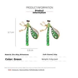 Detail of green dragonfly earrings with white rhinestones and zinc alloy finish