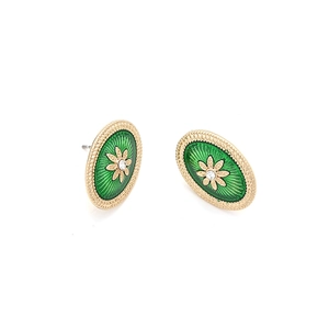 Detail of vintage oval stud earrings with green enamel inlay and gold flower accent