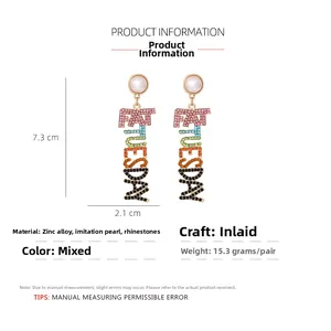 Detailed view of FAT TUESDAY letter earrings with dimensions 7.3x2.1cm and rhinestones
