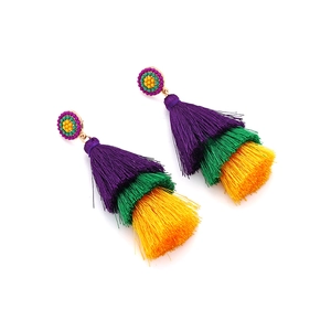 Macro detail of multi-layer purple green and yellow silk fringe drop earrings