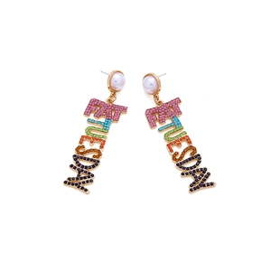 Macro detail of Fat Tuesday letter earrings featuring colorful rhinestones and pearl studs