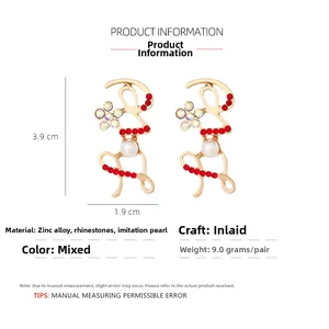 Detailed size view of gold alloy LOVE earrings with red rhinestones and pearls