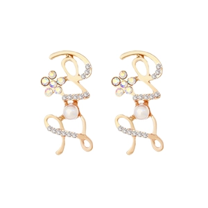 Golden LOVE letter earrings with faux pearls and sparkling rhinestones on white background
