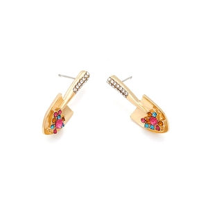 Macro shot of gold shovel earrings with colorful crystals and sparkling rhinestones