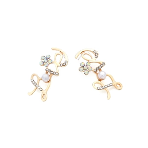 Detailed close-up of golden LOVE earrings with pearls and shimmering rhinestones