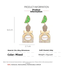 Detail view of sparkling Tequila bottle earrings with rhinestones and green lemon slice