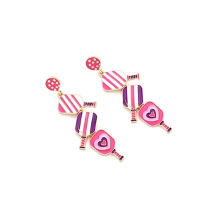 Close-up of pink and purple enamel pickleball paddle drop earrings with heart details