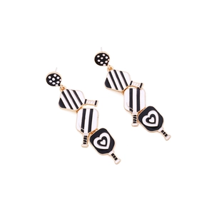 Black and white pickleball paddle drop earrings in gold alloy with heart and polka dot patterns