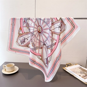 Detail of pink vintage carriage pattern scarf draped elegantly on a metal stand
